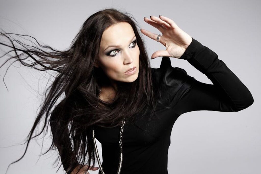 Tarja Turunen dressed in black, her long hair flying behind her