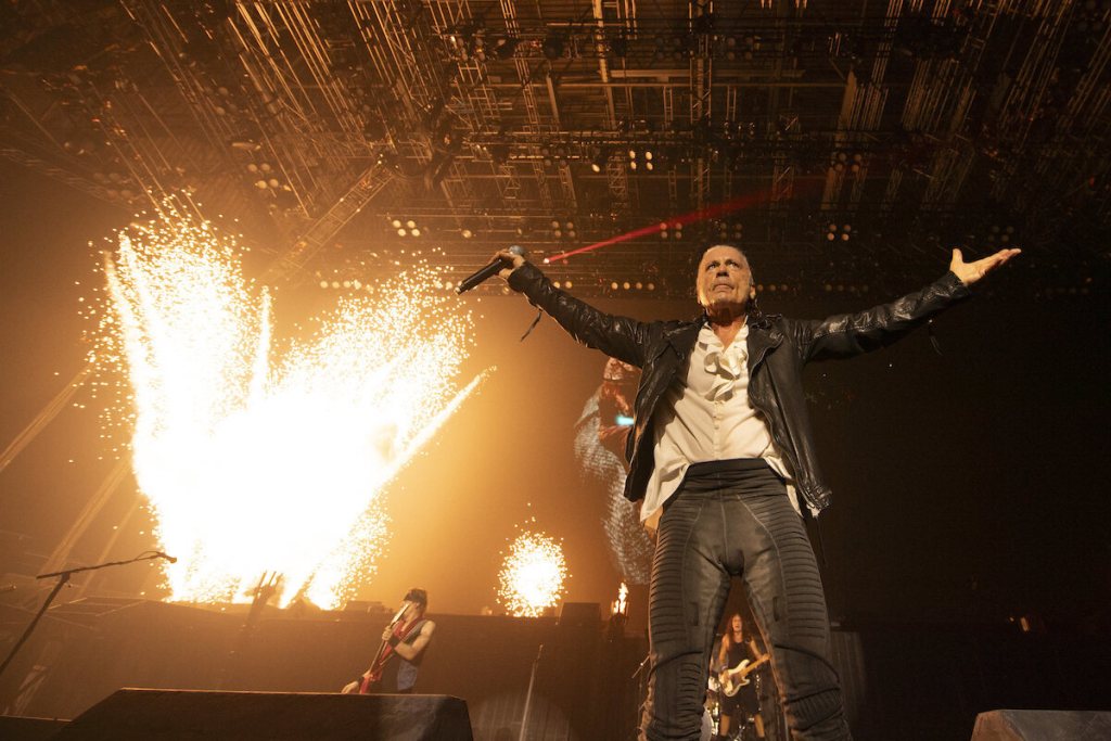 Iron Maiden's lead singer stands on stage with arms wide open